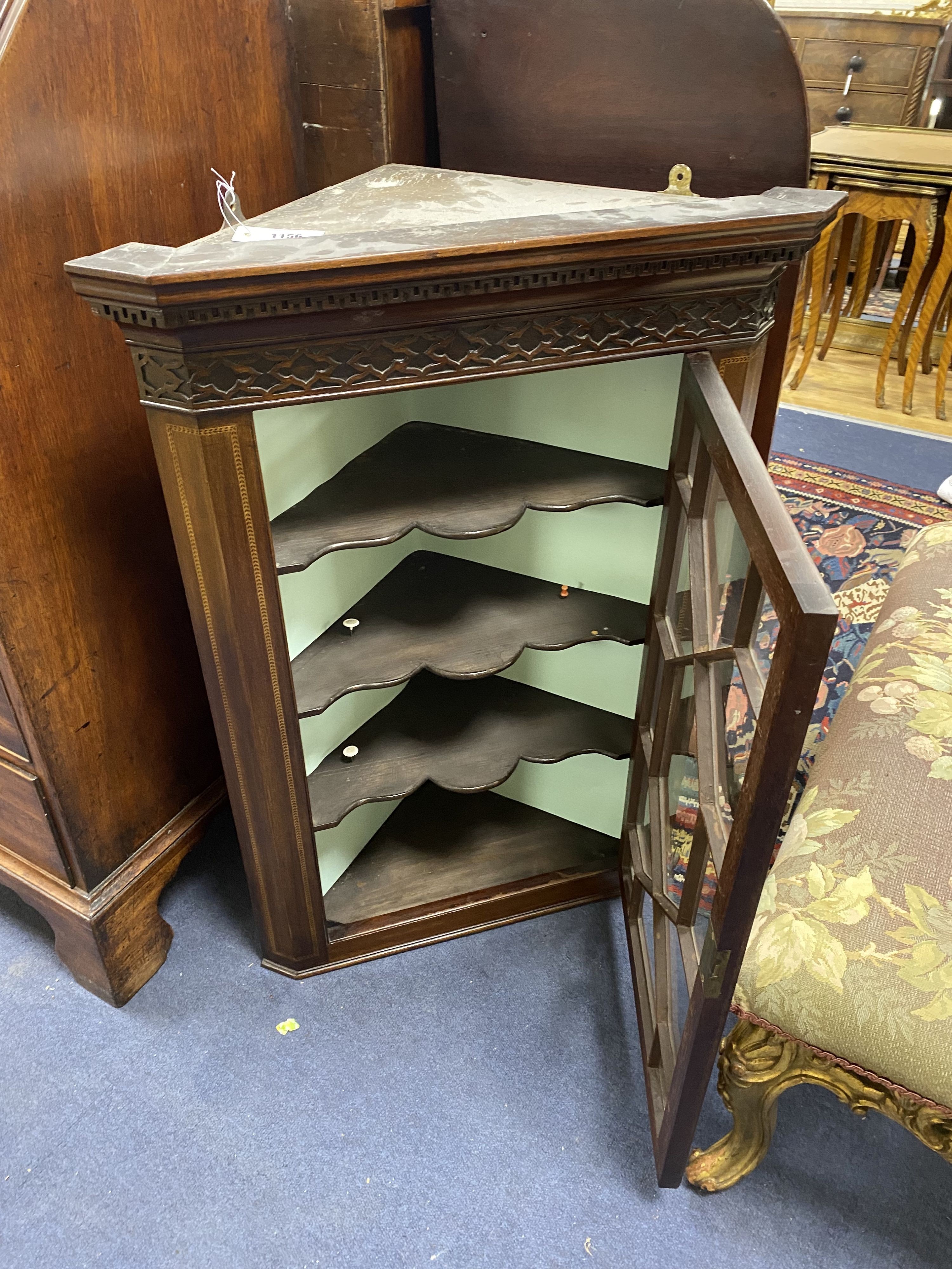 A George III style mahogany hanging corner cupboard, width 62cm, depth 35cm, height 87cm
